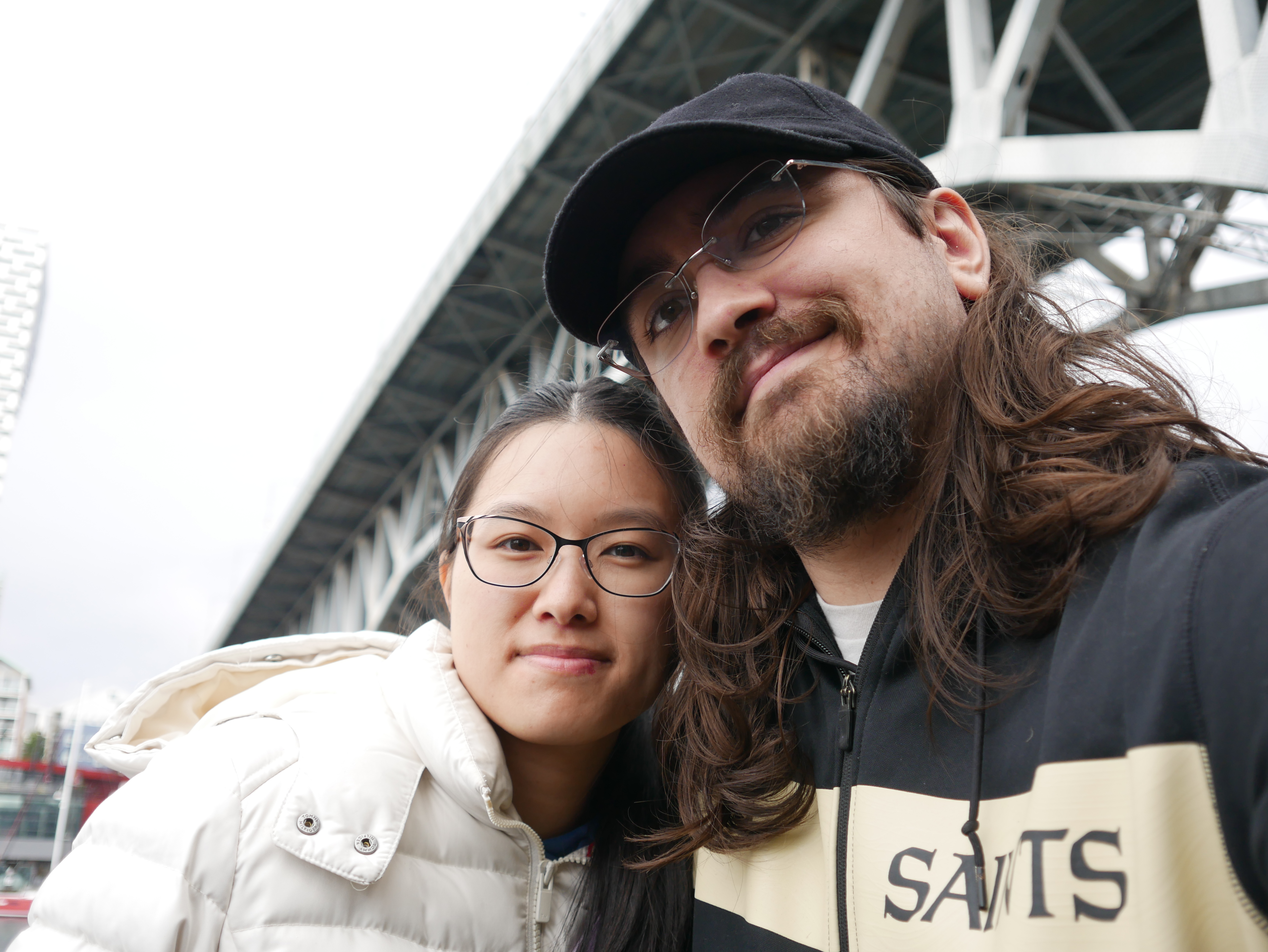 Megan and Andrew on Granville Island in Vancouvery, with Granville Bridge overhead.